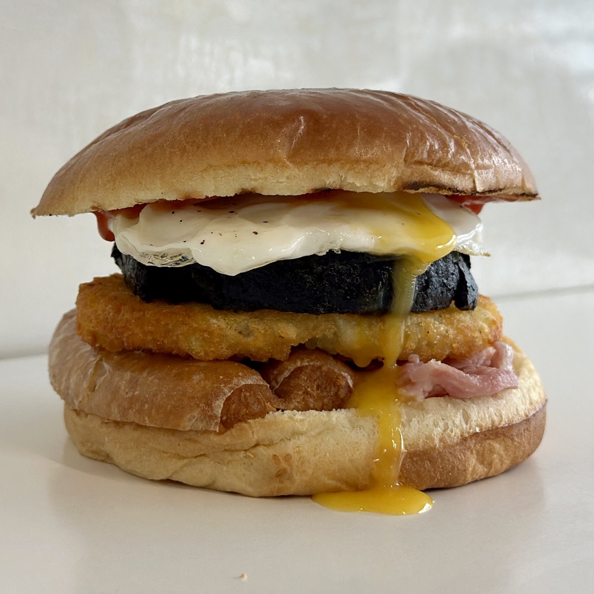 Full breakfast roll with fried egg, black pudding, tattie scone and bacon, part of this week's specials